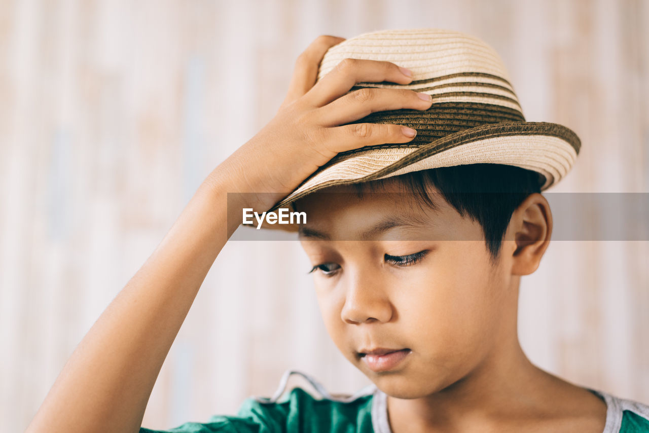 Close-up of boy wearing hat