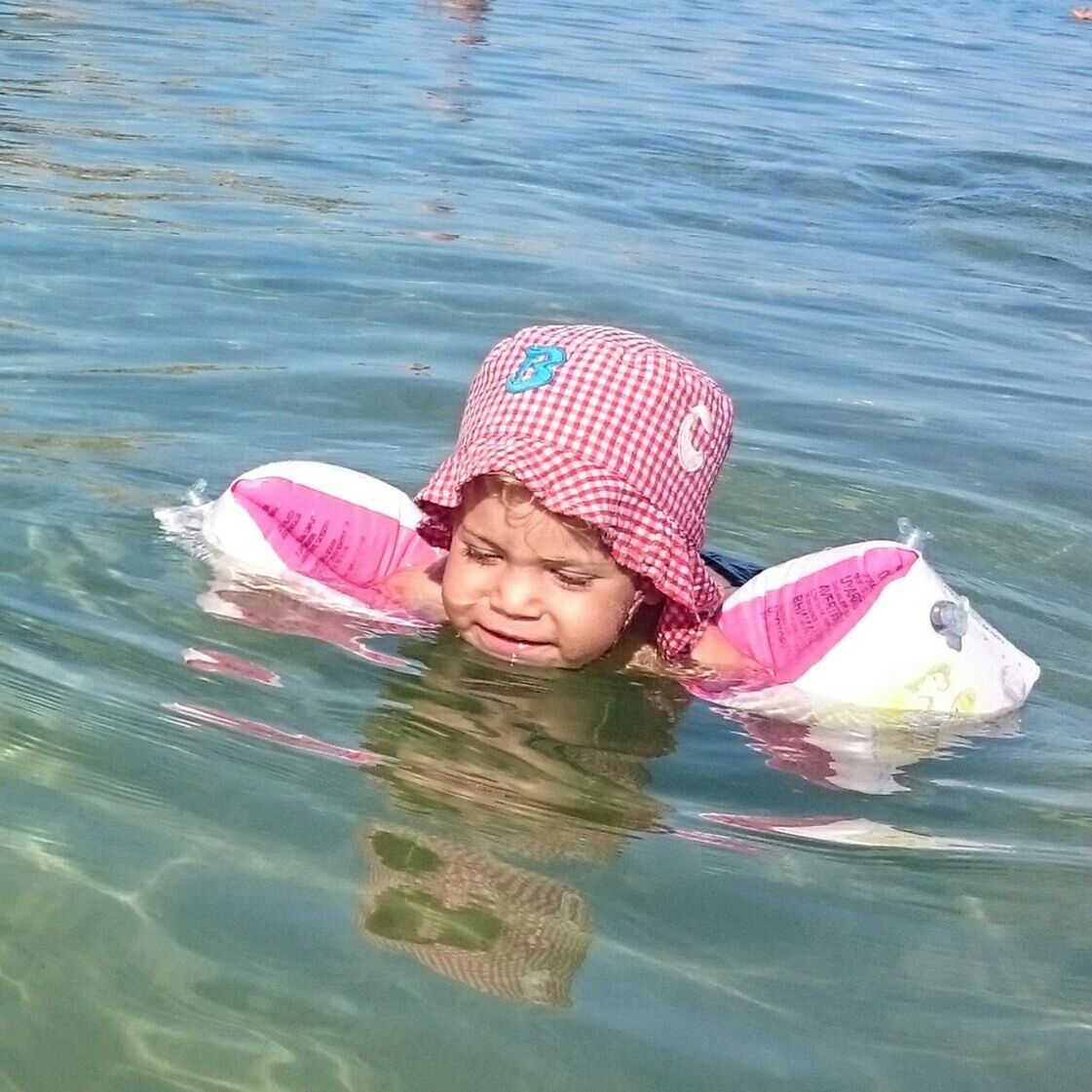 Cute girl swimming in sea