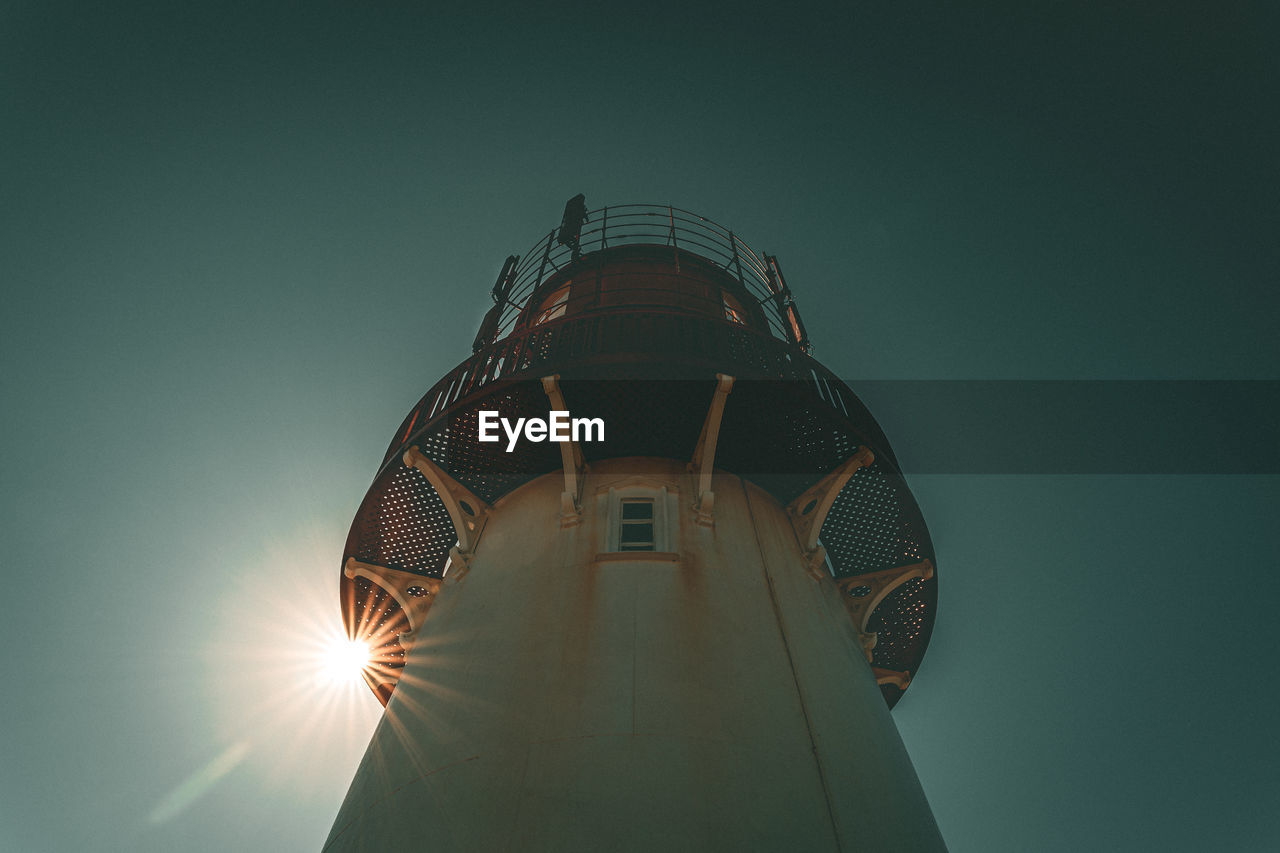 Low angle view of illuminated tower against clear sky