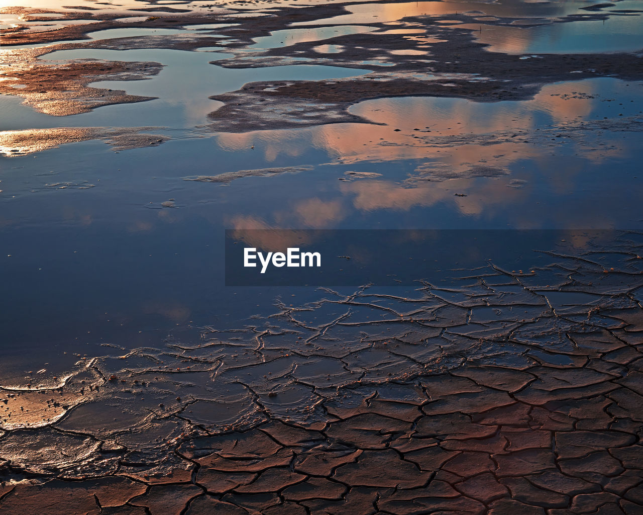 High angle view of reflection in puddle on lake