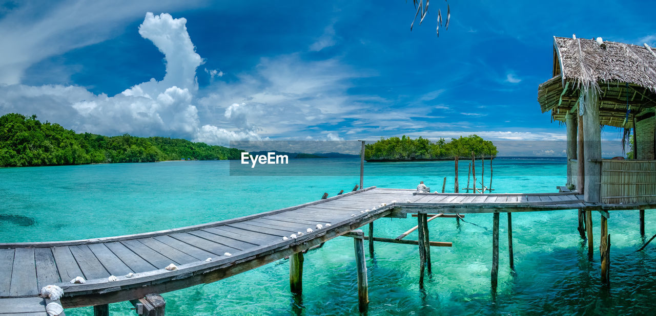 Panoramic view of swimming pool by sea against sky