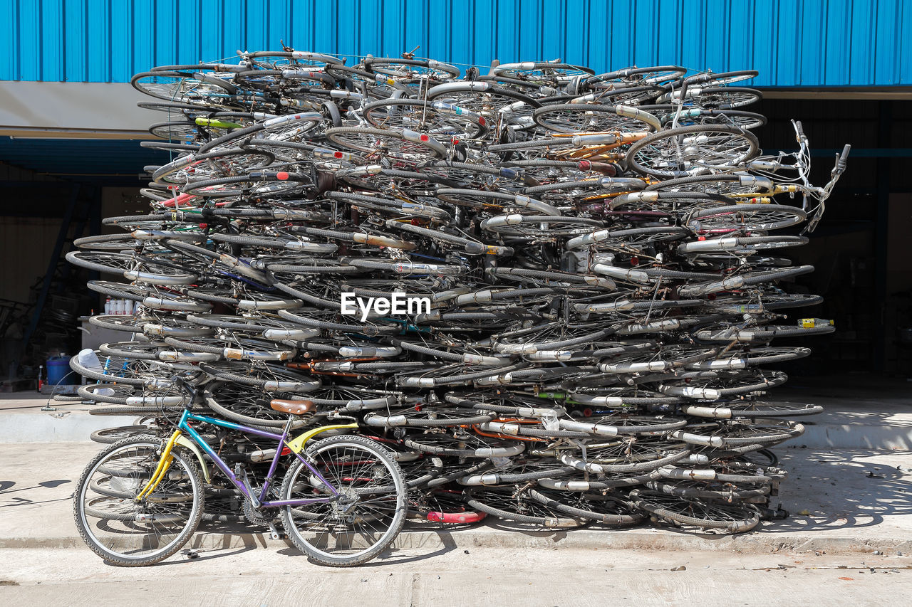 BICYCLES PARKED BY STACK OF FISH