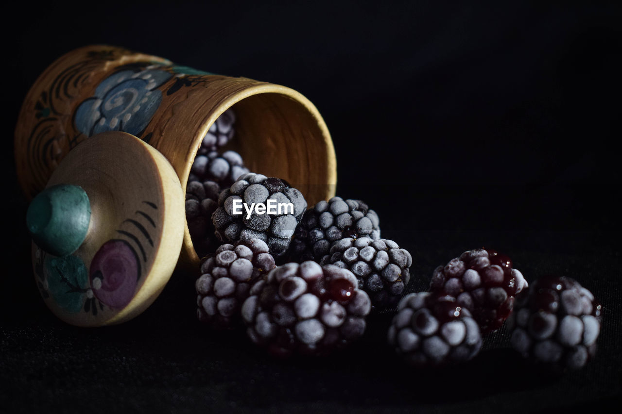 Frozen blueberries in a barrel on the table in the summer of 2018