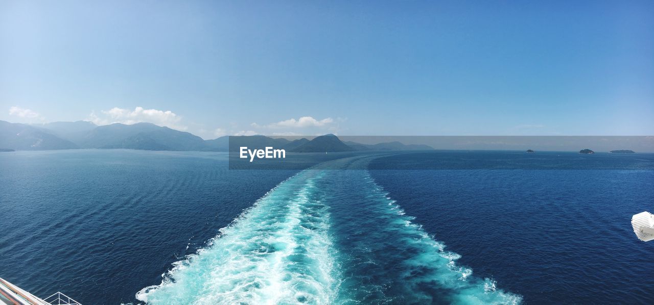 Scenic view of sea against blue sky