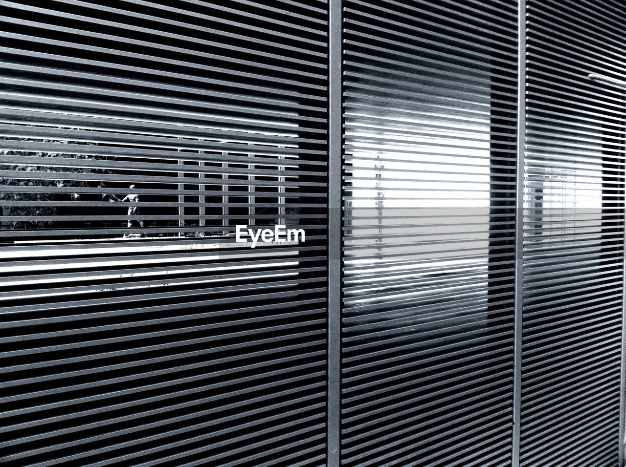 Walking person seen through metal grid