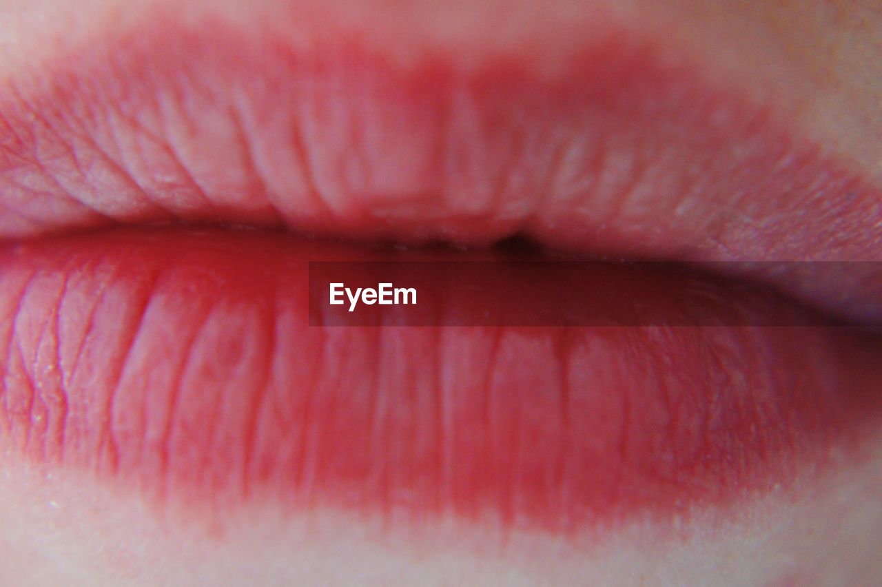 Extreme close-up of woman pink lips