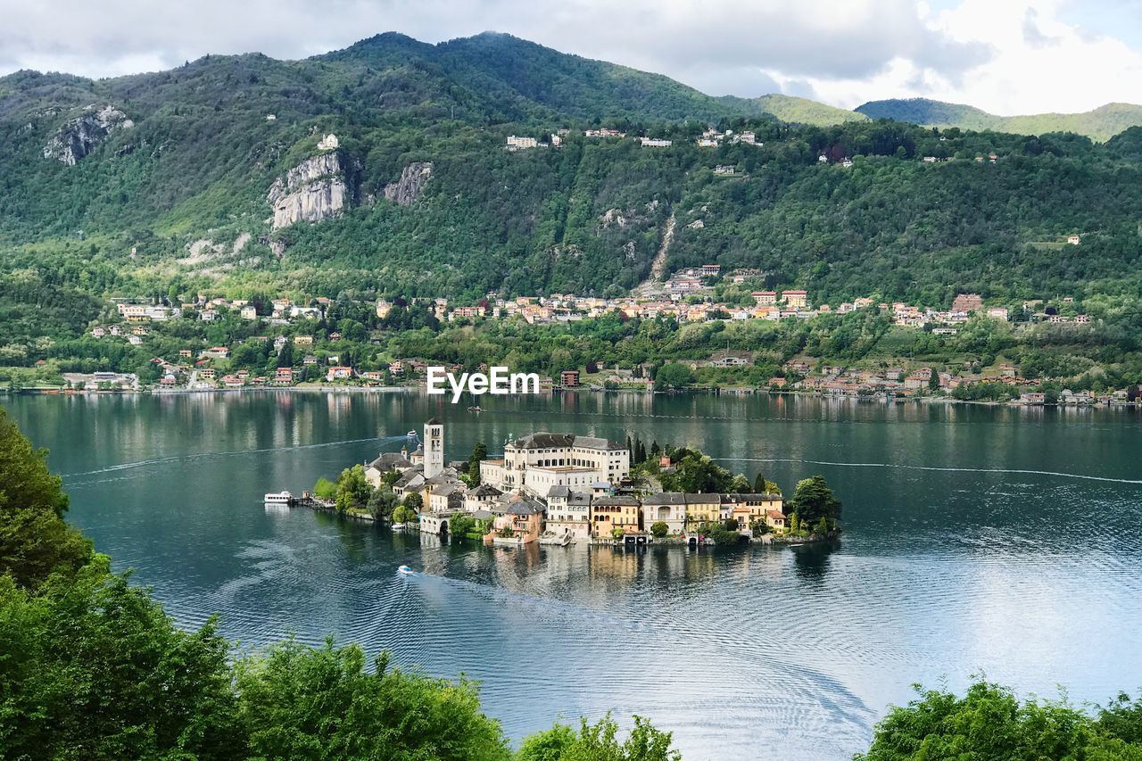 Aerial view of island on lake by mountain