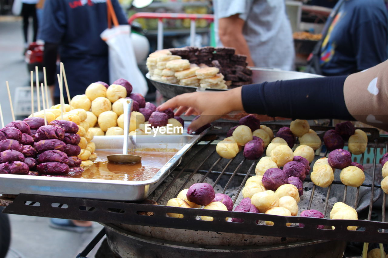 Midsection of man preparing food at market