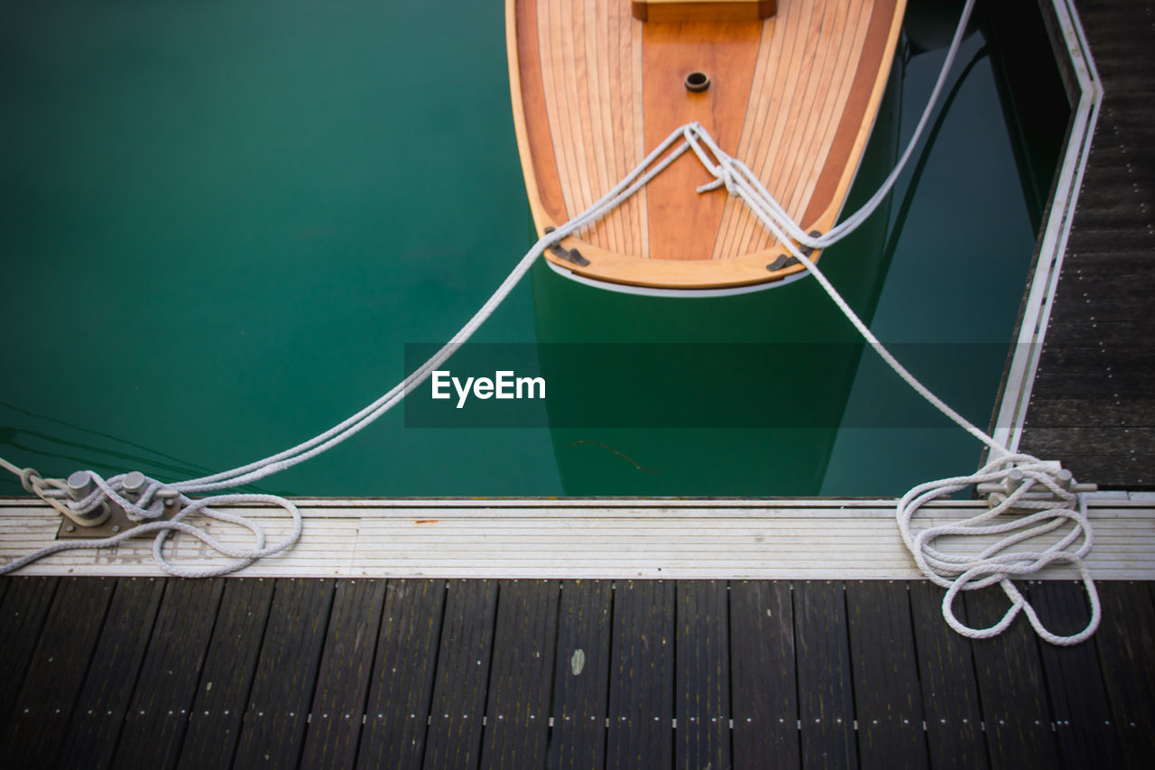 High angle view of ropes tied on wooden floor