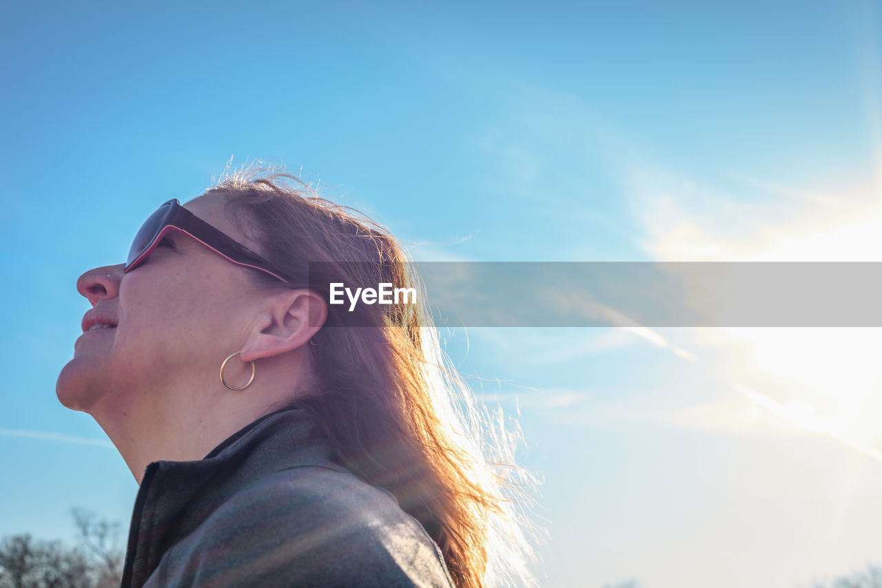 Smiling woman against sky