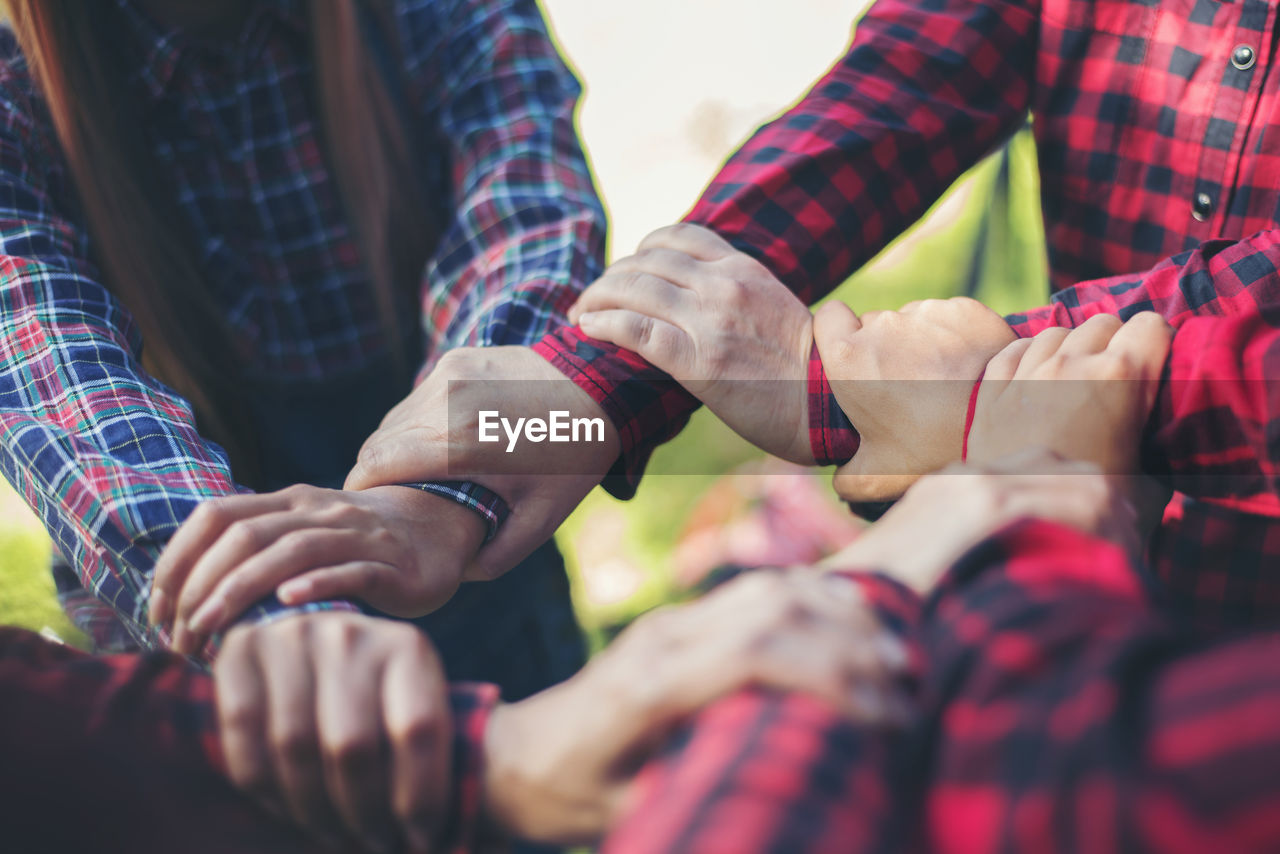 Cropped image of people forming hand chain