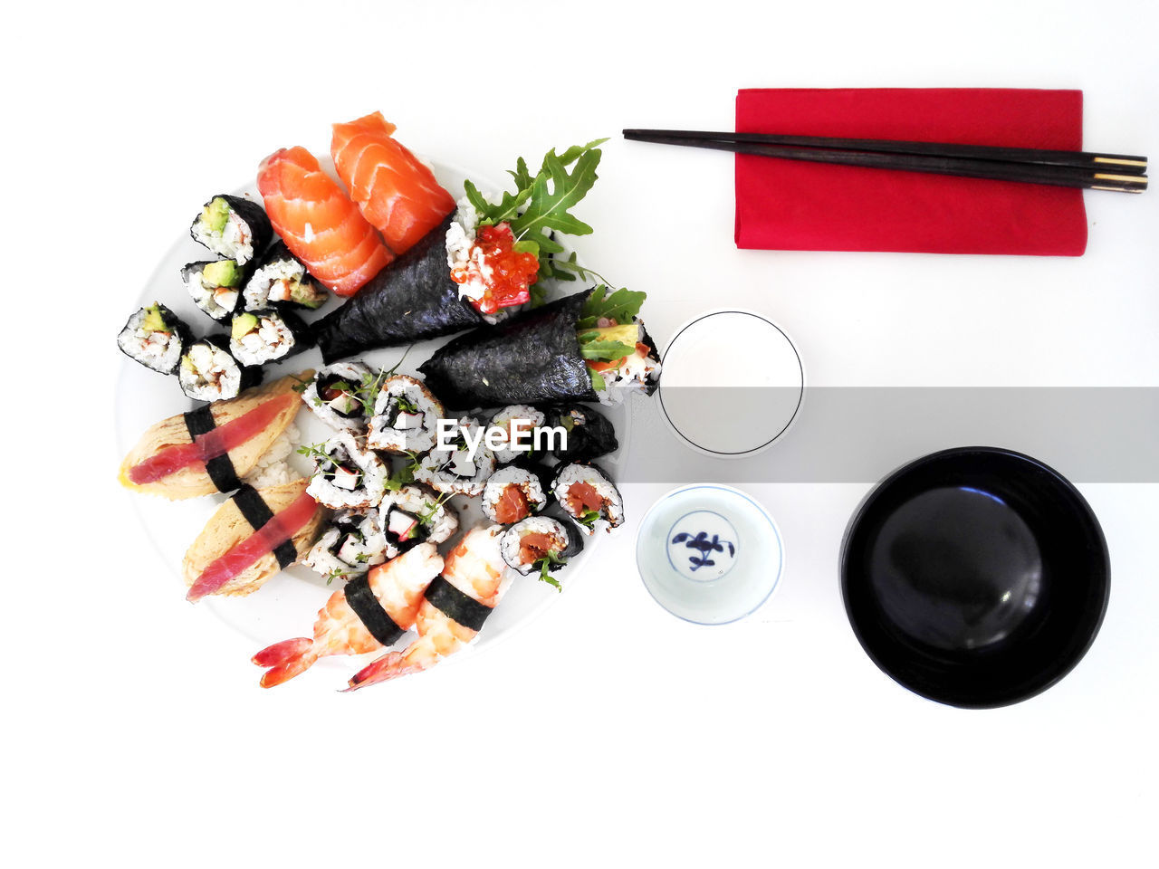 High angle view of sushi in plate by chopsticks on table