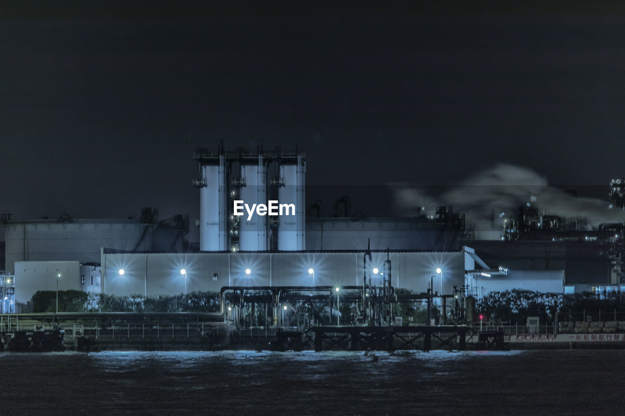 VIEW OF FACTORY AGAINST SKY AT NIGHT