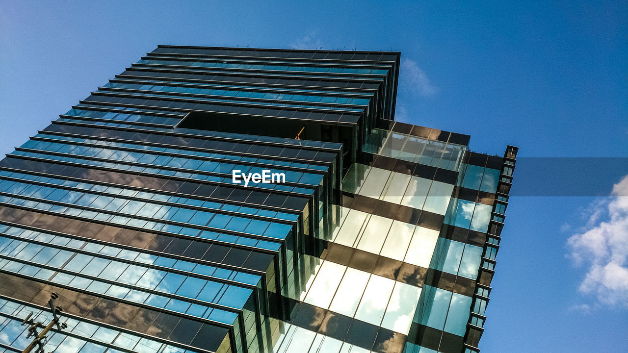 Low angle view of modern building against clear blue sky