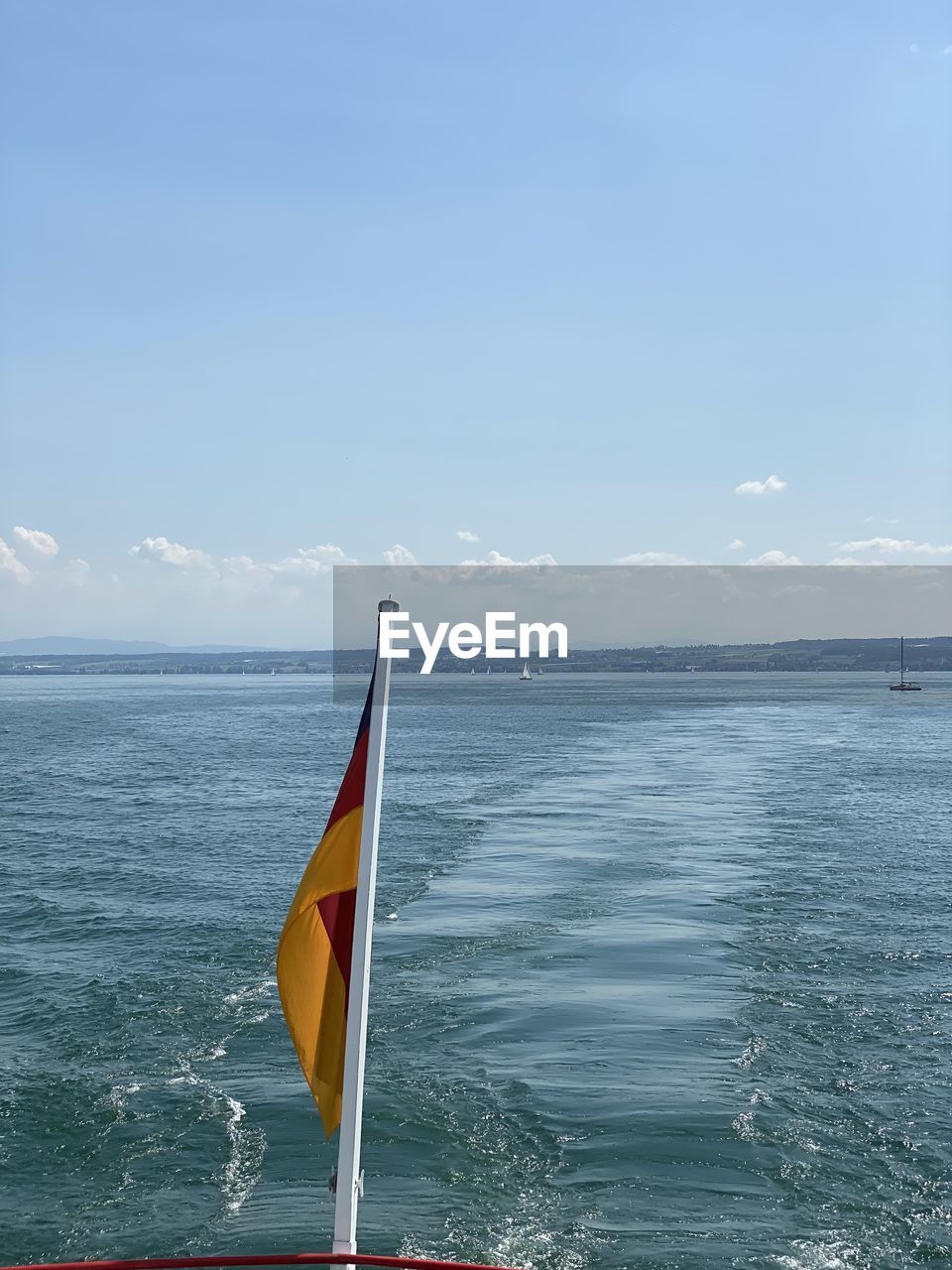 VIEW OF FLAG ON SEA AGAINST SKY
