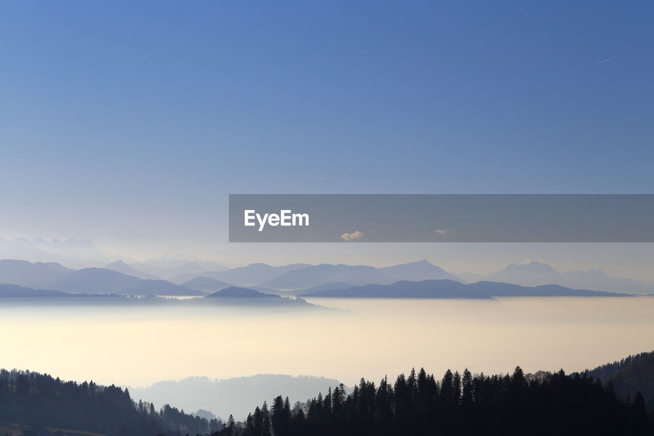 Scenic view of mountains against sky at sunset