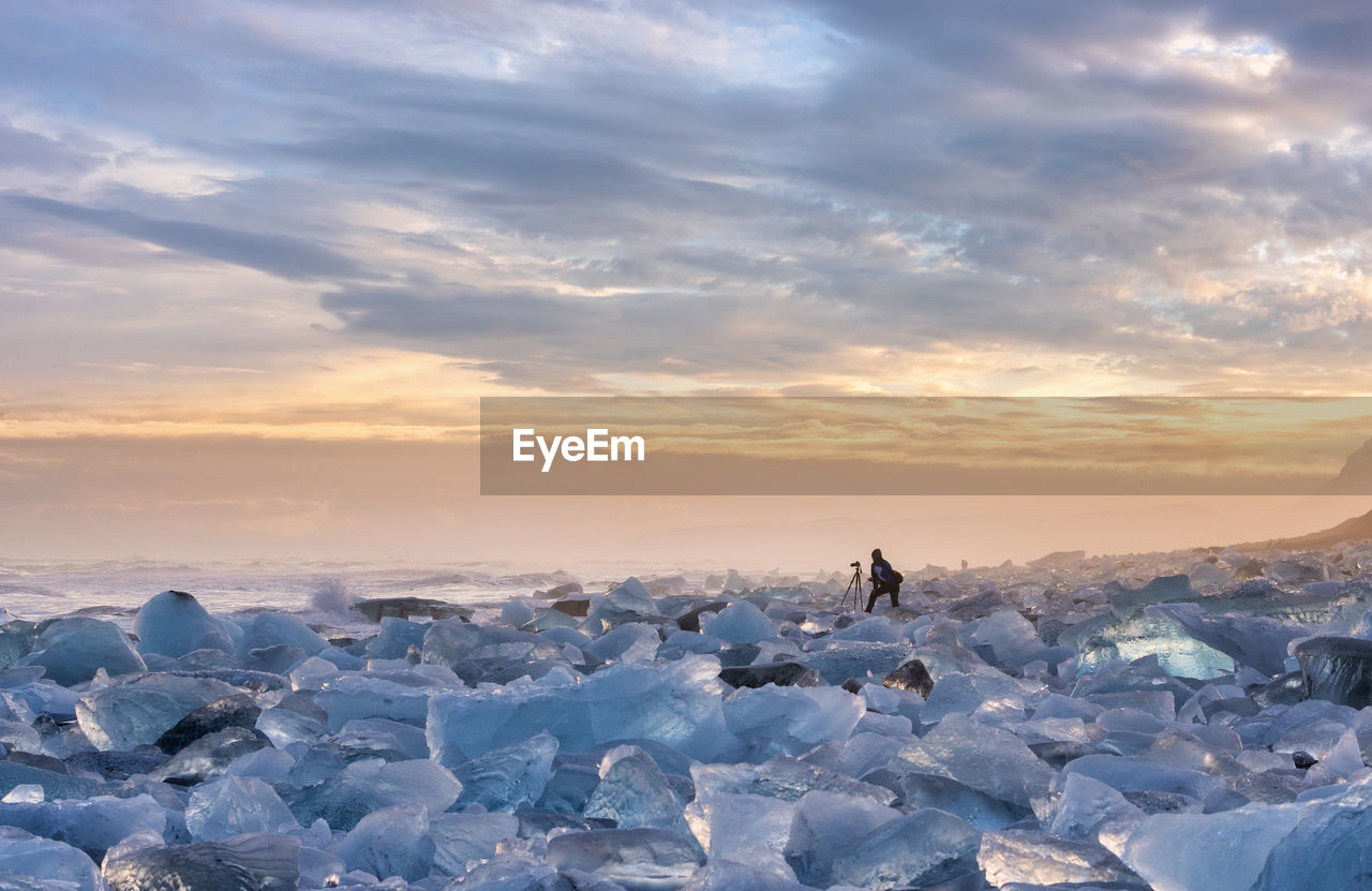 Scenic view of snow covered landscape against sky during sunset