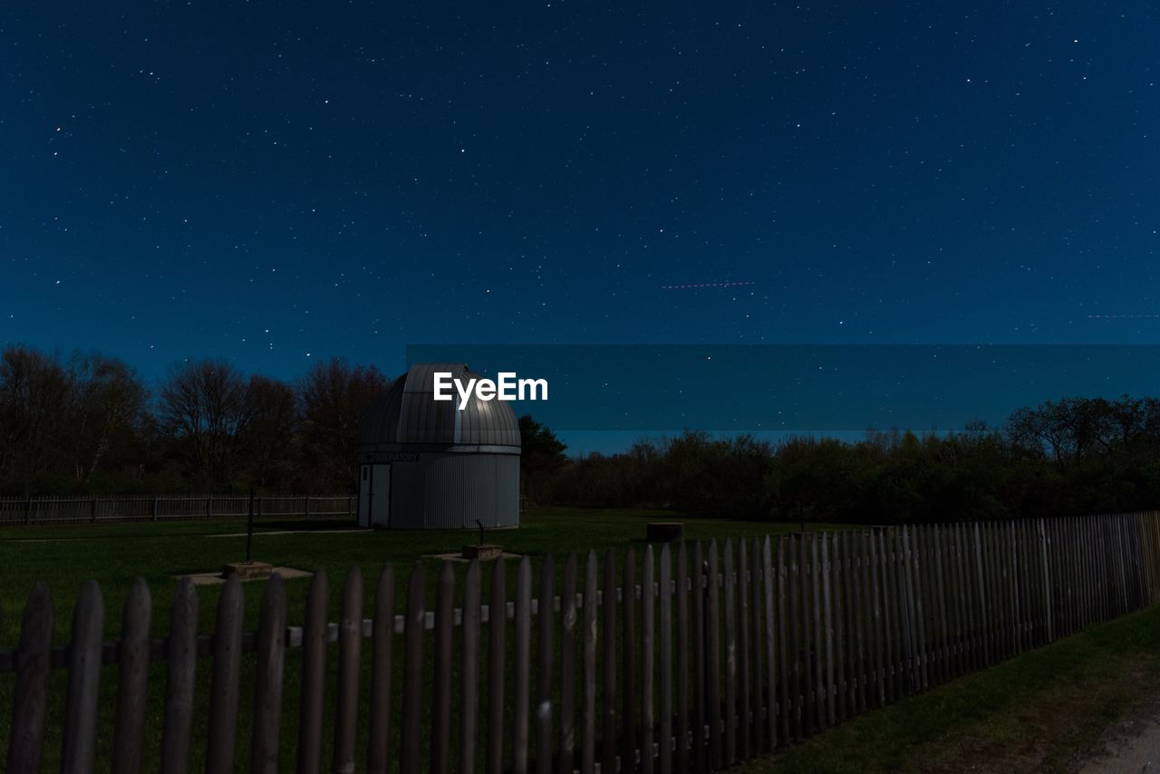 BUILT STRUCTURE AGAINST TREES AT NIGHT