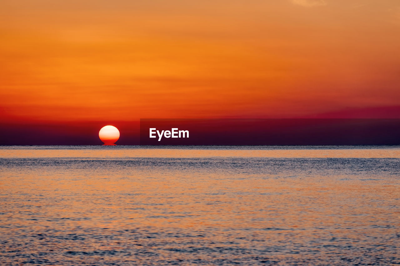 SCENIC VIEW OF SEA DURING SUNSET