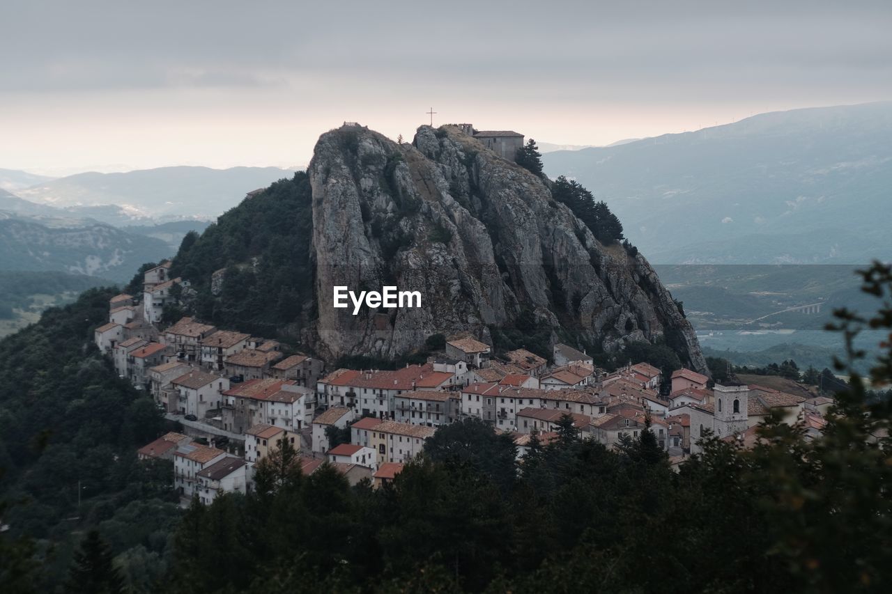 Townscape by mountain against sky