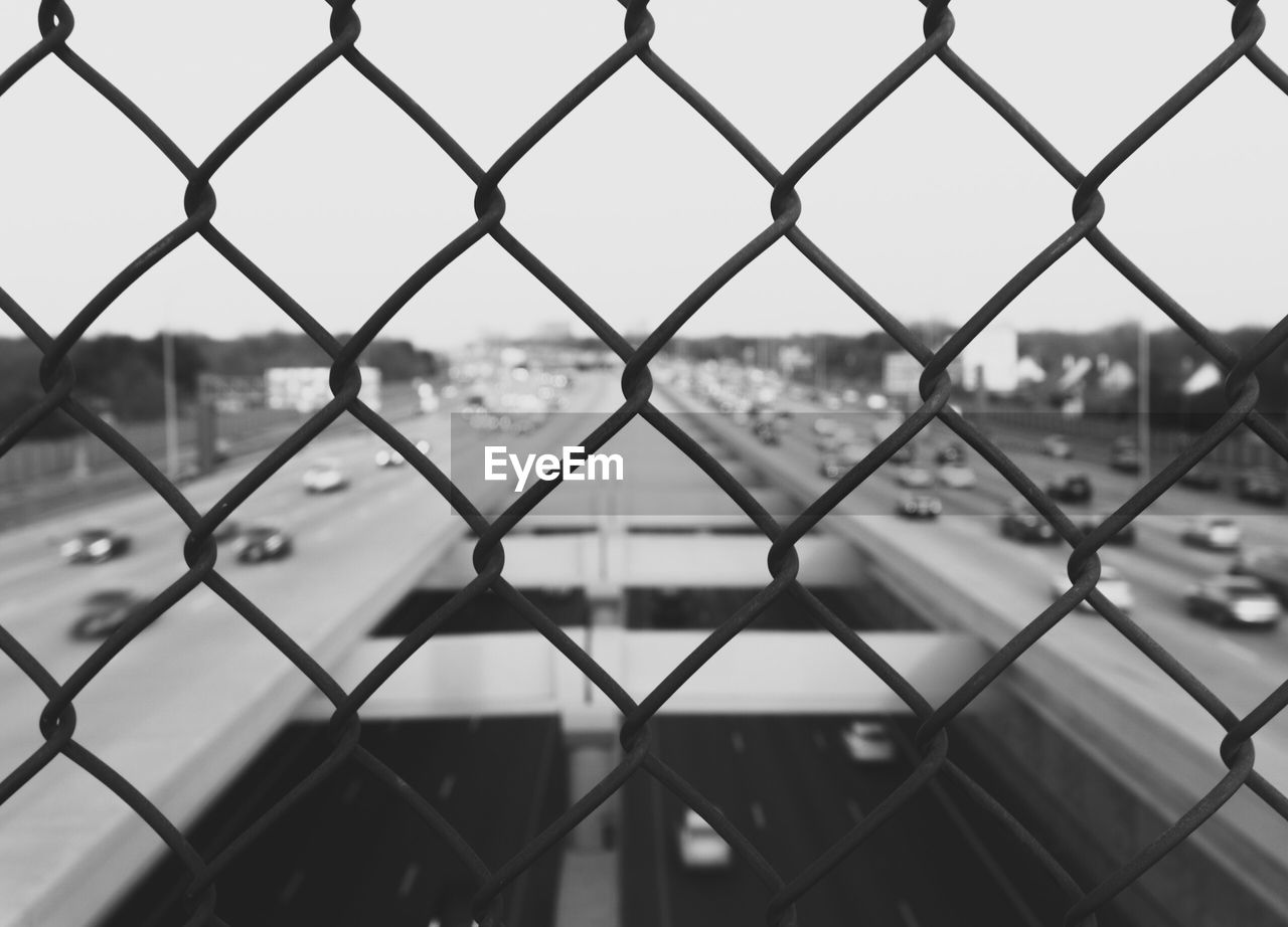 Close-up of chainlink fence against sky