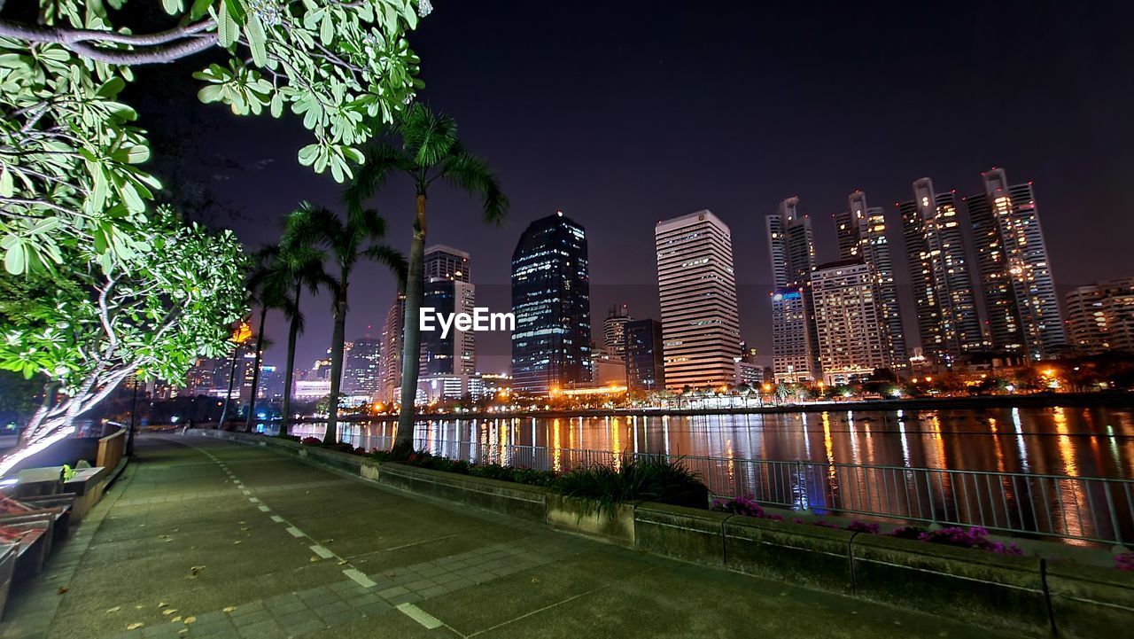 ILLUMINATED CITY BUILDINGS AT NIGHT