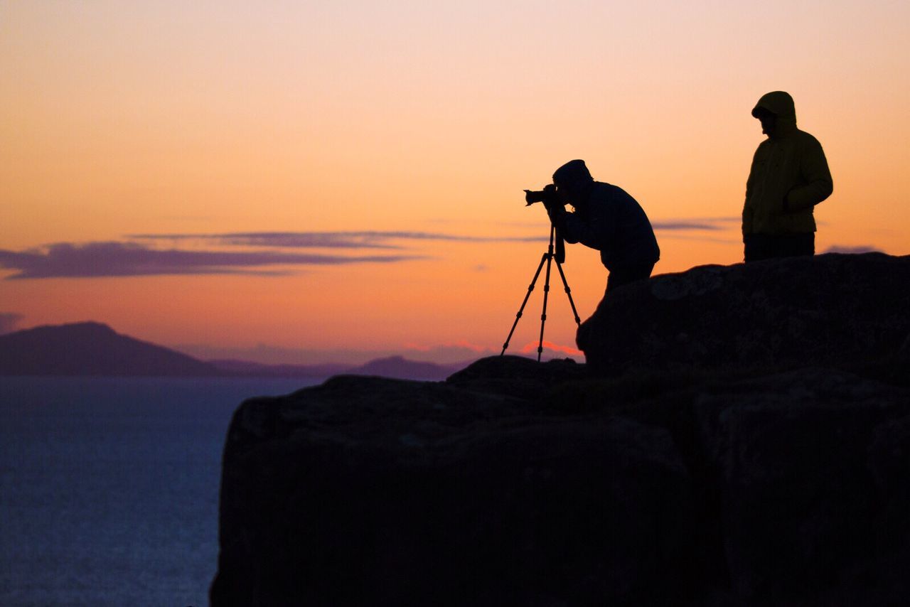 Side view of a silhouette photographer
