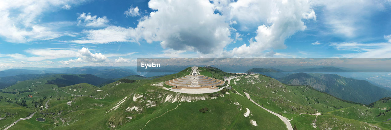 PANORAMIC VIEW OF MOUNTAINS AGAINST CLOUDY SKY