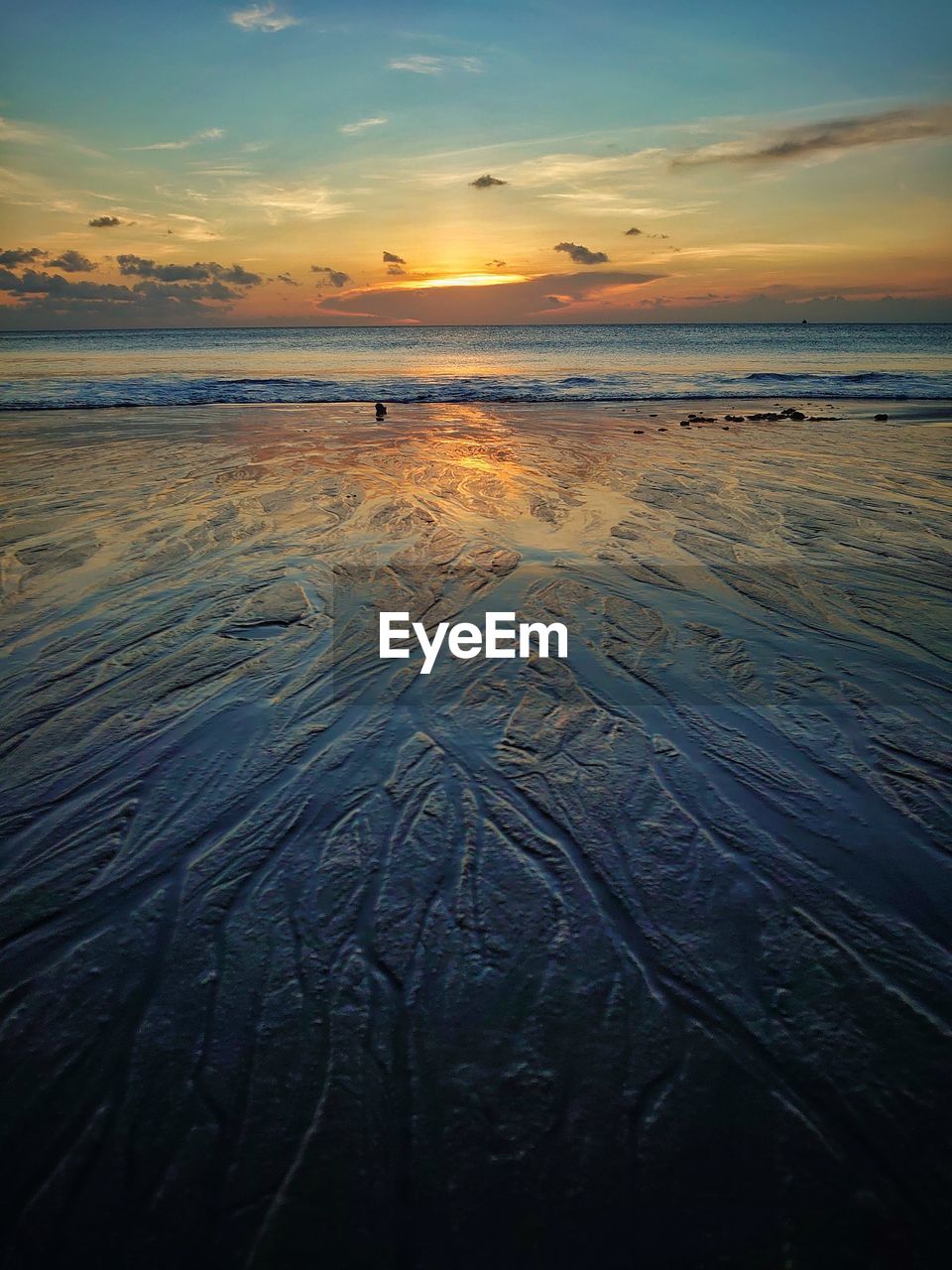 Scenic view of beach against sky during sunset