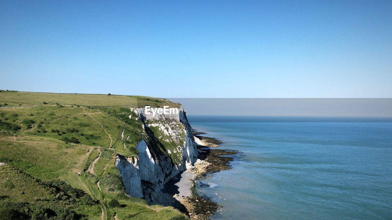 Scenic view of sea against clear blue sky