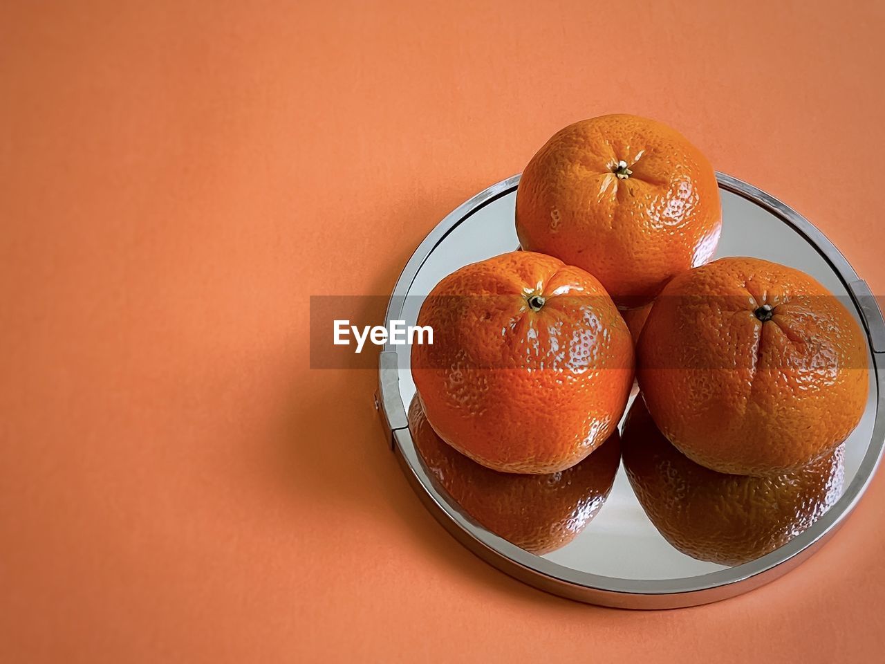 HIGH ANGLE VIEW OF ORANGES IN BOWL ON TABLE