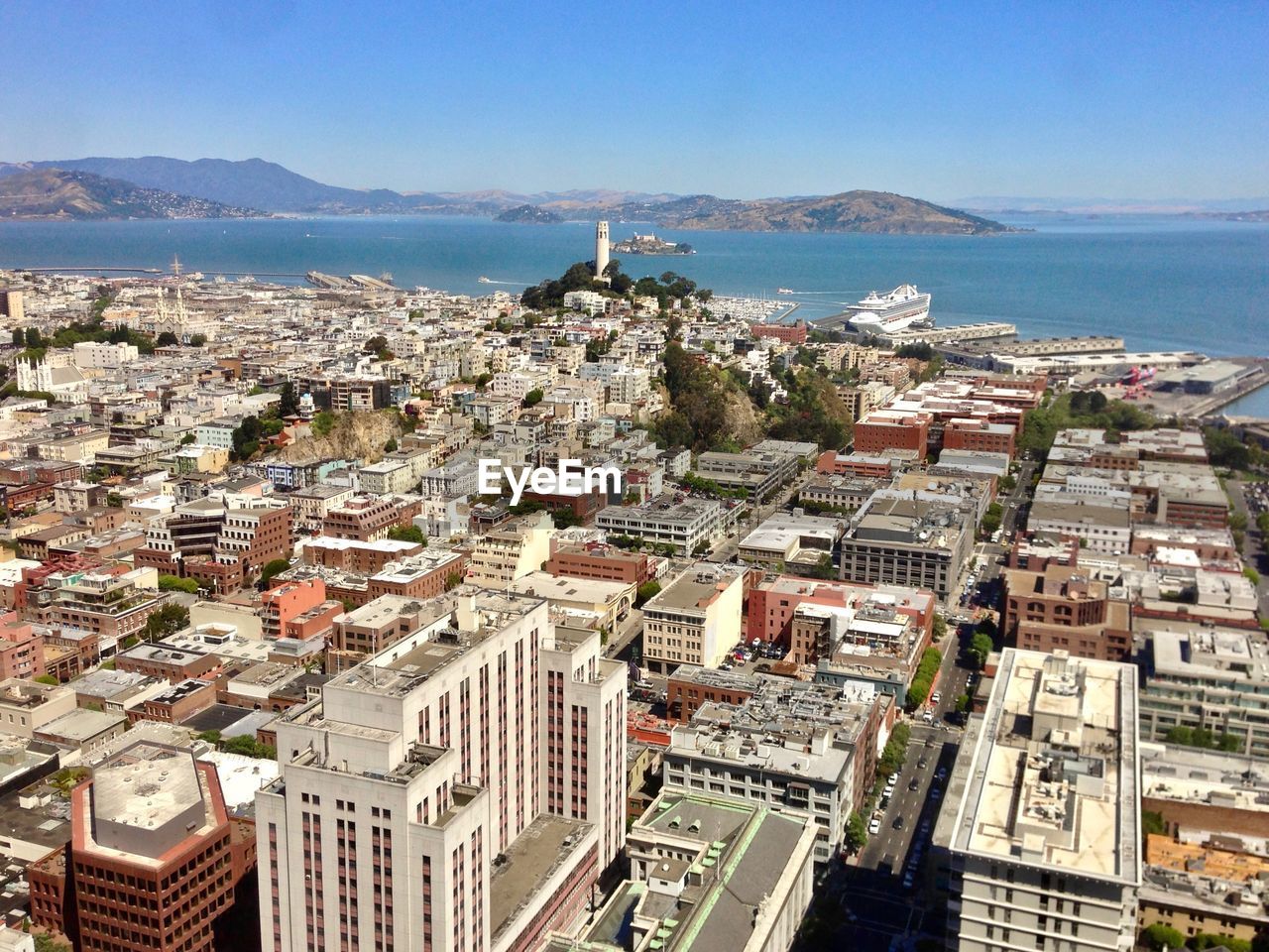 High angle view of townscape by sea against sky