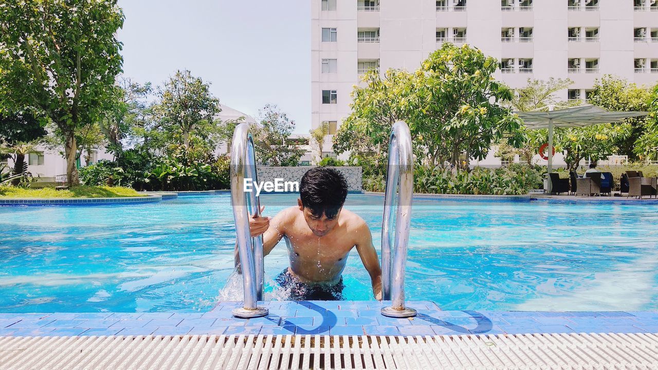 Shirtless man in swimming pool