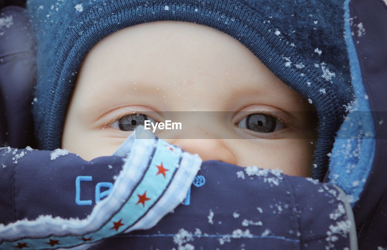 Close-up portrait of baby girl in snow