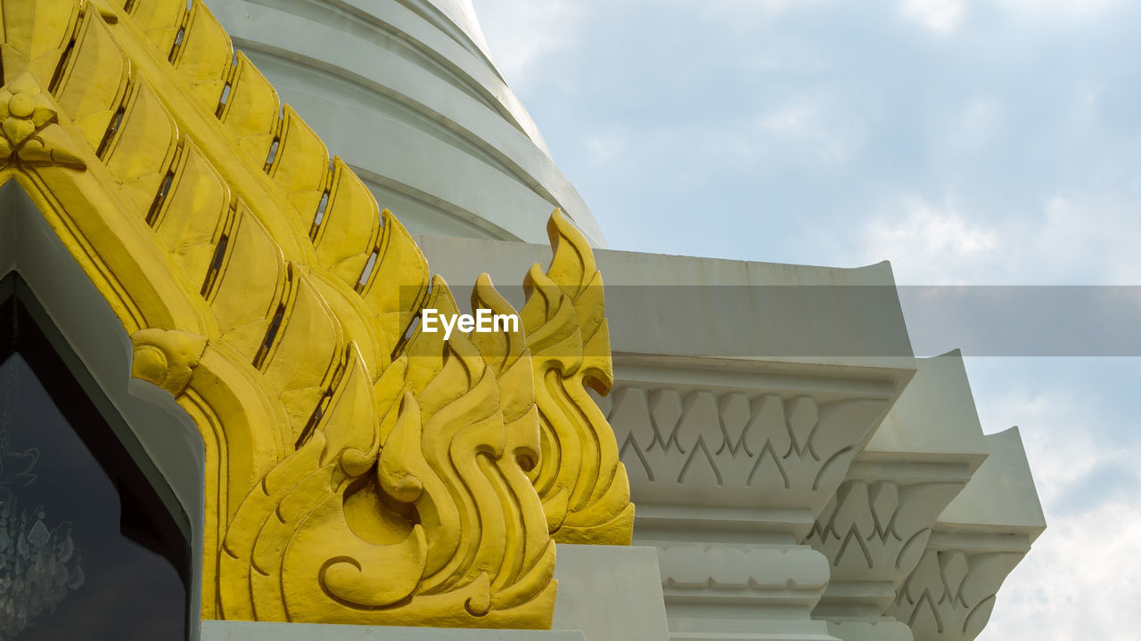 Low angle view of yellow built structure against sky