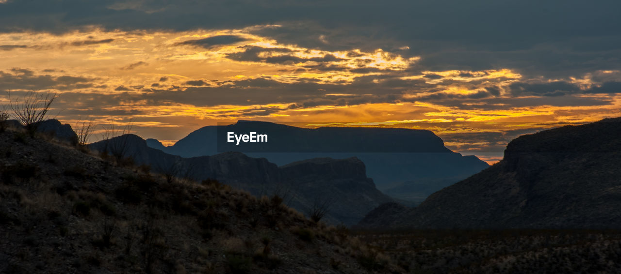 SCENIC VIEW OF MOUNTAINS DURING SUNSET