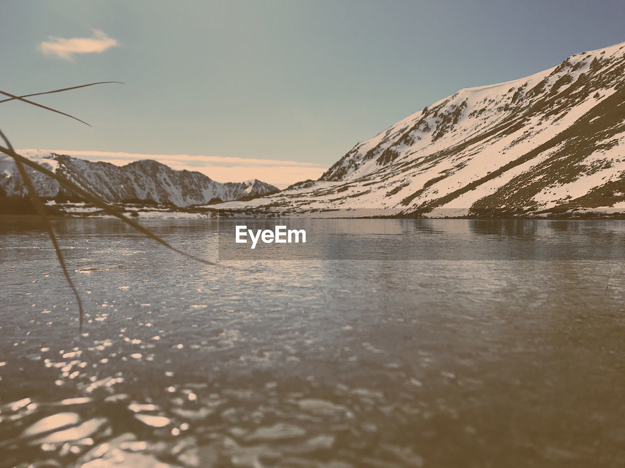 Scenic view of lake against sky during winter