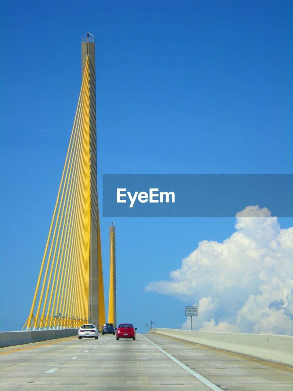 SUSPENSION BRIDGE AGAINST BLUE SKY