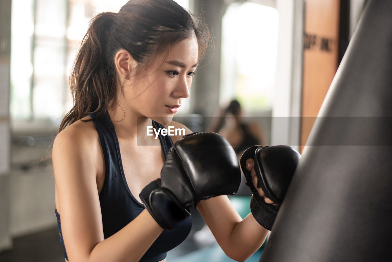 Determined woman boxing at gym