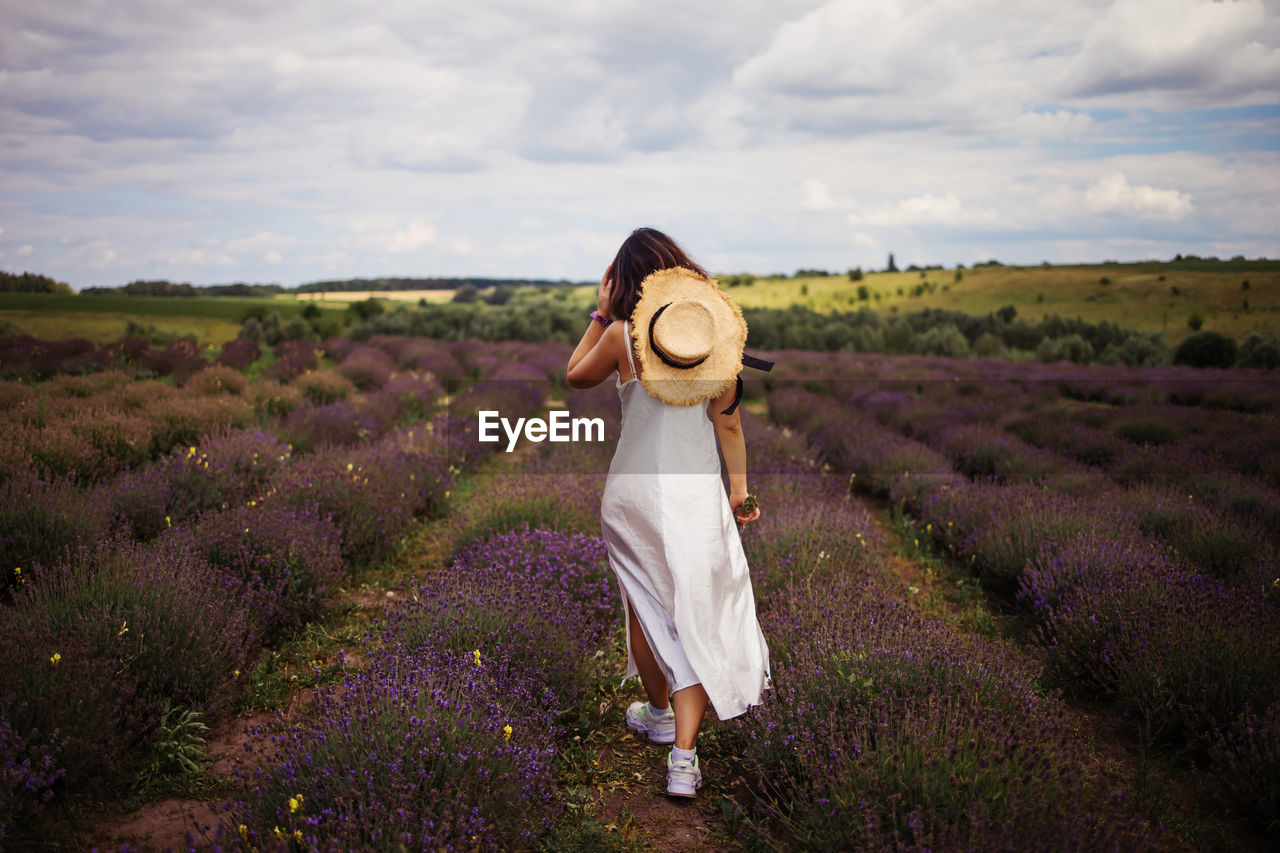 Woman walking in lavender field
