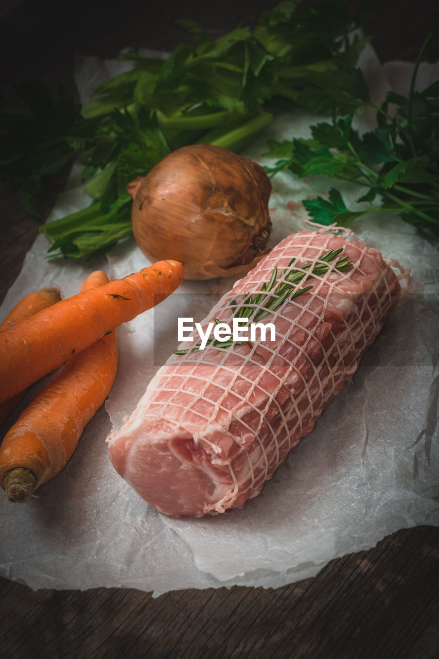 High angle view of vegetables and meat on wooden table