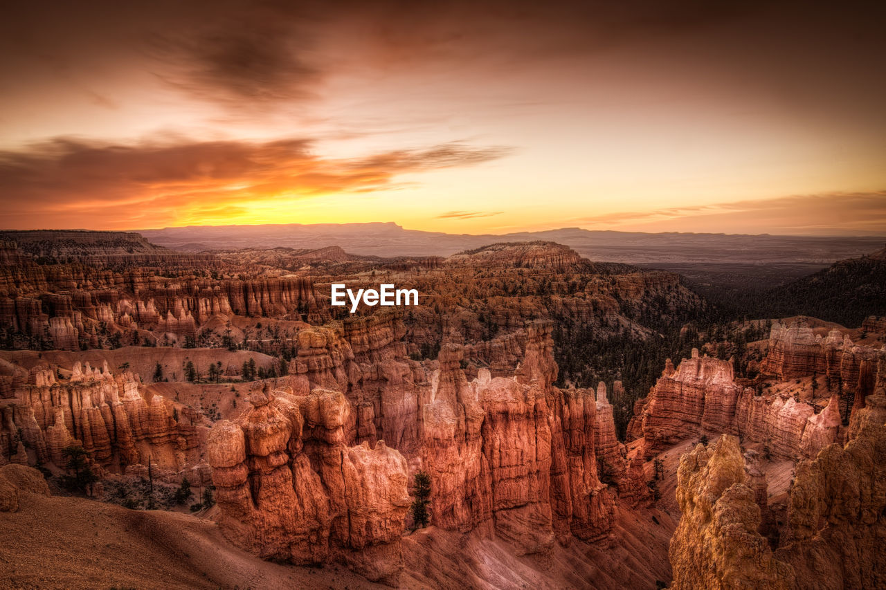 Scenic view of mountains against cloudy sky