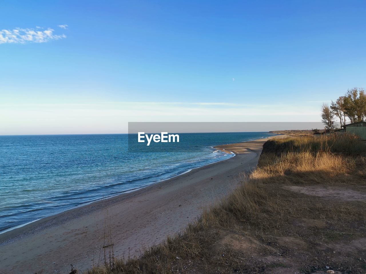 sea, water, sky, land, beach, shore, body of water, horizon, coast, scenics - nature, ocean, beauty in nature, horizon over water, nature, sand, tranquility, tranquil scene, wave, plant, vacation, bay, blue, no people, day, terrain, coastline, clear sky, non-urban scene, cliff, idyllic, tree, outdoors, travel destinations, travel, cloud, environment, grass, landscape