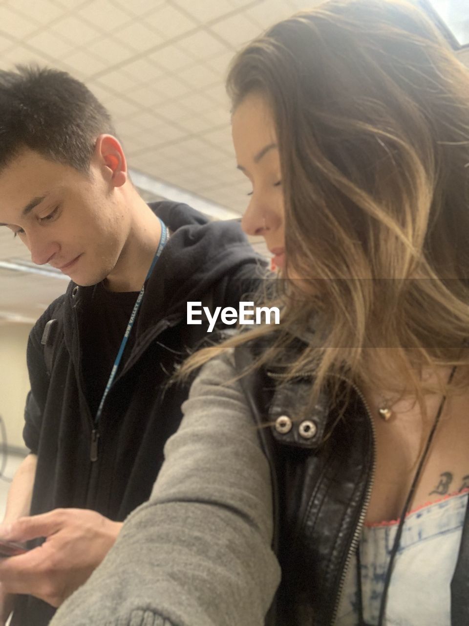 PORTRAIT OF YOUNG COUPLE LOOKING AT