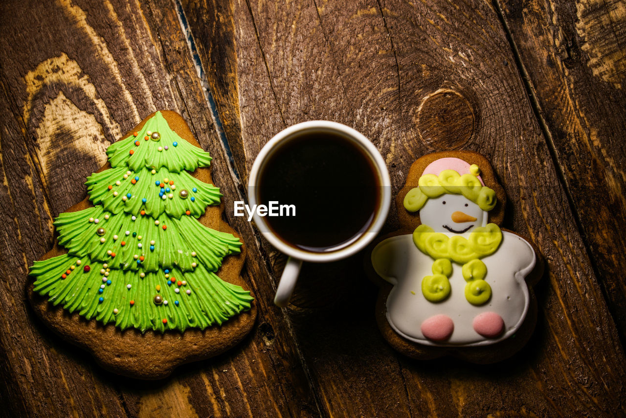 Overhead view of gingerbread cookies with coffee cup on table