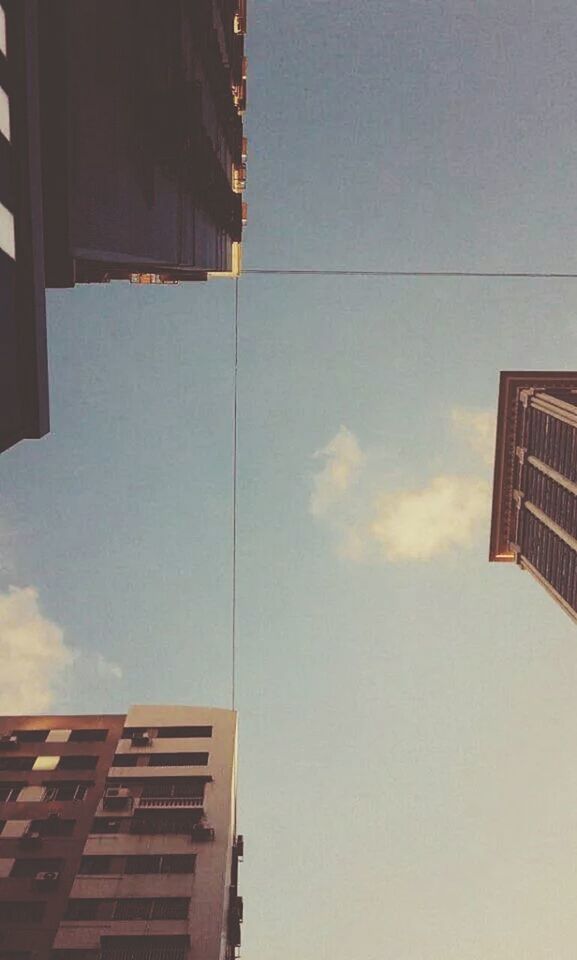 LOW ANGLE VIEW OF MODERN BUILDINGS AGAINST SKY