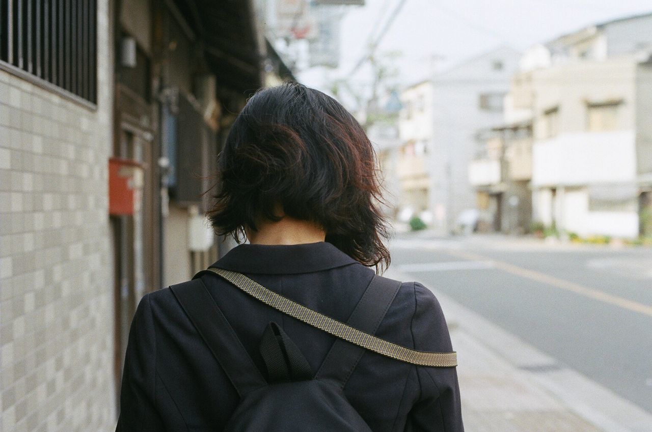 Rear view of woman standing on street
