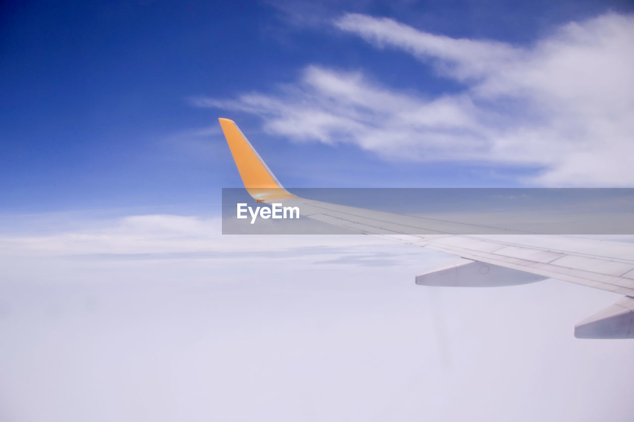 Airplane wing against sky