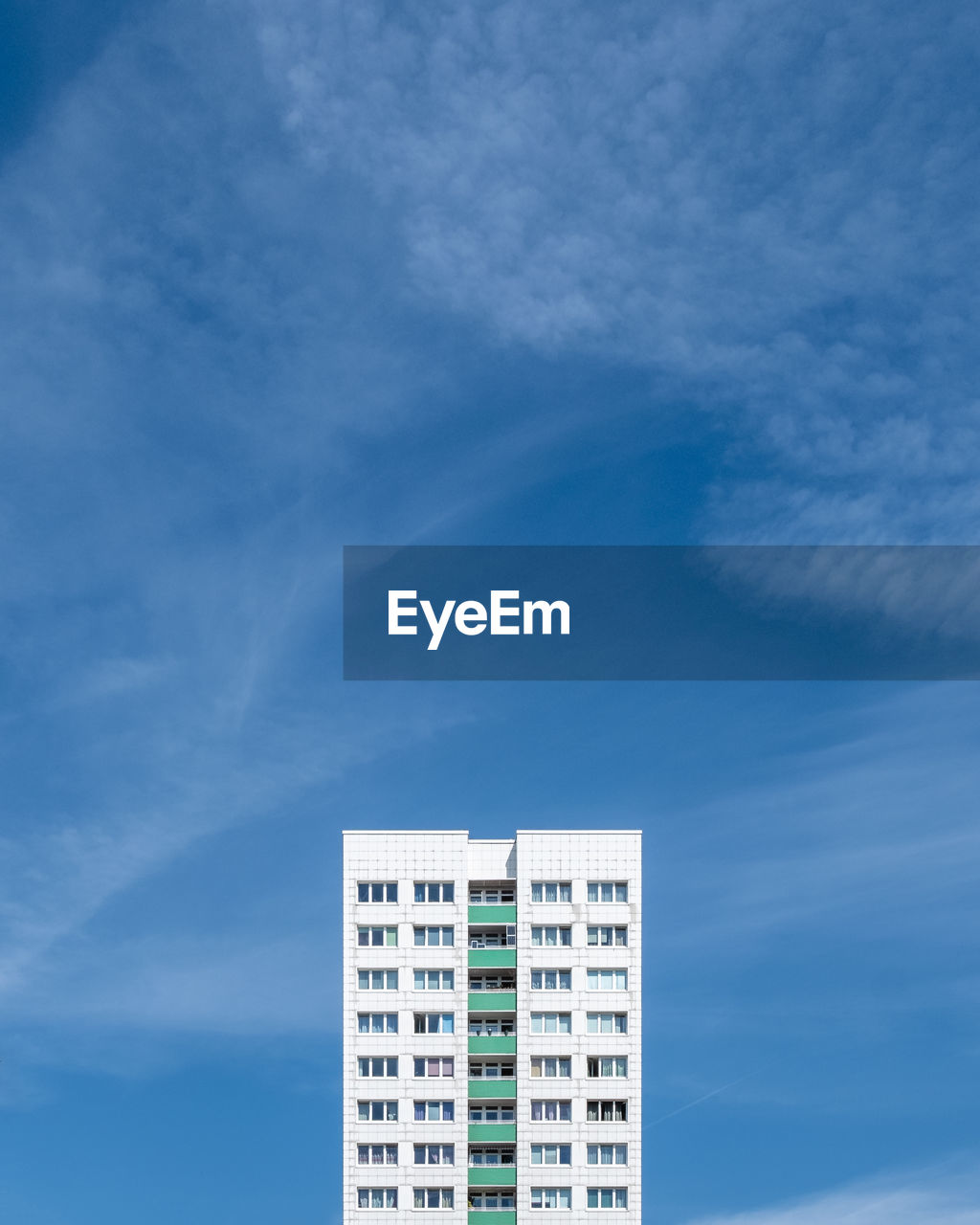 LOW ANGLE VIEW OF BUILDINGS AGAINST BLUE SKY