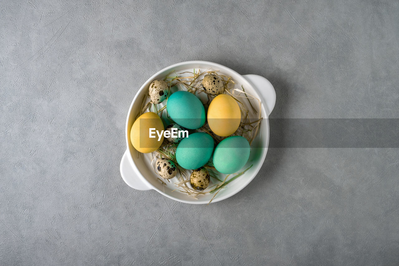 egg, food, gray background, food and drink, easter, high angle view, tradition, easter egg, gray, studio shot, indoors, copy space, no people, celebration, directly above, holiday, still life, animal egg, multi colored